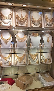 Bridal gold necklace sets displayed across the cabinets at Ramzan Jewellers, Glasgow